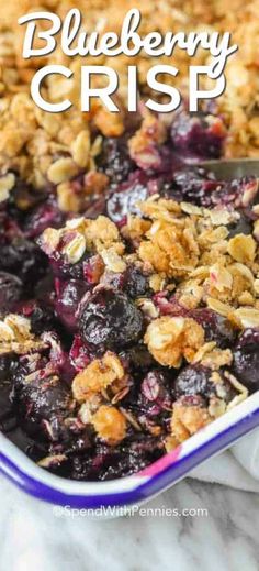 blueberry crisp in a glass baking dish with a serving spoon and title overlay