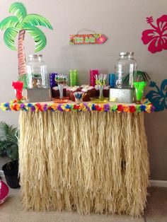 a table topped with lots of food and drinks on top of a carpeted floor