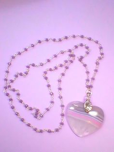 "Very pretty Peachblow Onyx heart pendant   Silver plated 30\" chain with faceted lilac  agate gem stone beads at about one inch intervals. The heart is striped with lilac, pink and clear colours.Perfect for Valentine's present." Purple Heart-shaped Beaded Jewelry, Heart-shaped Necklace With Faceted Beads For Gift, Heart-shaped Faceted Beads Necklace For Gift, Lavender Beaded Chain Jewelry For Gifts, Sterling Silver Flower Earrings, Valentines Presents, Silver Flower Earrings, Lilac Pink, Sterling Silver Marcasite