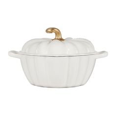 a white ceramic pumpkin dish with gold trim