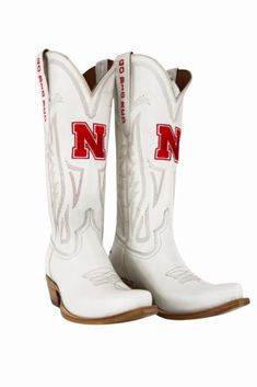 Women's Collegiate Gameday Boots in Ivory Details Available in sizes 5 - 13 INCLUDING 1/2 SIZES Premium Geniune Ivory Leather Goodyear Welt Construction Memory Foam Insole Smooth Leather Lining Natural Stacked Wood Heel Western Embroidery Stitching Embroidered Team Logos Snip-toe Pull on Style with V Front and Back 14" Shaft Height and Circumference CLC Approved Sizing Sizes 5 - 13 to include 1/2 sizes! Fit Boots run 1/2 size small. Size up 1/2 size. Western Style White Ankle Boots, White Western Ankle Heeled Boots, White Knee-high Boots With Reinforced Heel, White Snip Toe Heeled Boots, Western High Ankle Boots With Reinforced Heel, Western White Mid-calf Boots With Reinforced Heel, White Leather Knee-high Boots With Round Toe, Western White Snip Toe Knee-high Boots, White Leather Knee-high Boots With Reinforced Heel