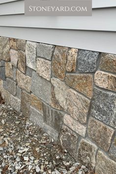 the side of a house that has stones on it and text overlay reads stoneyard com