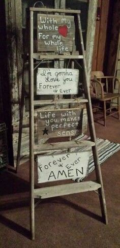 an old wooden ladder with signs on it in front of a building that says, little things for me