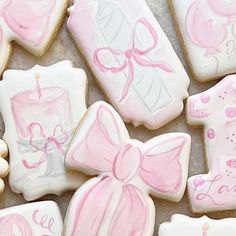 decorated cookies with pink and white icing are displayed