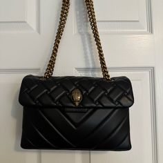 The Leather Kensington Bag Is Crafted From Soft Lambskin Leather Combining Both Weave And Chevron Patterns. The Antiqued Brass Eagle Head Features Opaque Brass Crystals And Black Crystal Eyes On The Front Flap. * 6.7in (H), 10.2in (L), 3.1in (D) * Strap Drop Cross Body: 43.7in * Strap Drop Shoulder: 25.2in * Antiqued Brass Chain Strap With Two Padded Leather Inserts * Duo Magnetic Snap Closure Hidden Under Flap * Gold Foil Embossed Logo On The Back * Can Fit Phones Up To 7 Inches * Two Interior Compartments With Small Internal Lining Pocket * Outer: Lambskin Leather * Interior: Monogrammed Interior Lining See Pictures For Condition. Slight Wear On The Bottom Corners. Not Very Noticeable. Us High-end Leather Bags With Chain Strap, High-end Black Leather Evening Bag, Designer Leather Bags With Chain Strap, Leather Evening Bag With Magnetic Closure In Luxury Style, Black Bags With Chain Strap For Everyday Luxury, Leather Shoulder Evening Bag, Leather Shoulder Evening Bag For Everyday Luxury, Luxury Leather Evening Bag With Magnetic Closure, Black Chain Strap Bags For Everyday Luxury