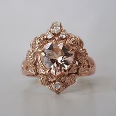 an antique style ring with a heart shaped diamond in the center