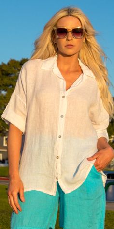 100% Linen Button Down Shirt with Dropped Shoulders and Rolled 3/4 Length Sleeves. 100% Linen Made in Italy One Size Model 5'8" Beach Button-up Blouse With Button Cuffs, Summer Shirt For Day Out With 3/4 Sleeves, Summer Blouse With 3/4 Sleeves And Button Closure, White Half Sleeve Top With Button Closure, Relaxed Fit Tops With 3/4 Sleeves And Button Closure, Summer Tops With Button Cuffs And Spread Collar, Casual Shirt With 3/4 Sleeves And Buttons, Relaxed Fit Top With 3/4 Sleeves And Placket, Summer Tops With 3/4 Sleeves And Placket