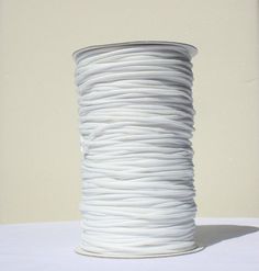 a roll of white cord sitting on top of a table