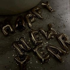 the word happy new year spelled out with balloons in front of a bathtub filled with water