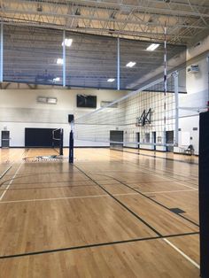 an indoor gym with hard wood floors and basketball hoops on the sidelines,