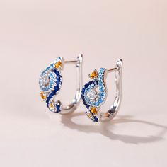 In a stunning display of style and craftsmanship, these earrings are brought to you. A combination of light blue, midnight blue, yellow gold and white stones, the earrings are a premium miniature version of Van Gogh's timeless Starry Night painting. This piece of work reminds us to trust our dreams and not believe the critics of the world. "There is always hope, even in the darkest of times." So trust your dream and let this alluring jewelry make a statement.Carat Weight: 2.584 ctStone Size: 2.5 Blue Diamond Drop Earrings For Anniversary, Luxury Blue Diamond Drop Earrings, Blue Gemstone Diamond Earrings For Anniversary, Blue Teardrop Diamond Earrings, Blue Diamond Gemstone Earrings For Anniversary, Blue Topaz Multi-stone Earrings, Luxury Blue Diamond Earrings With Accents, Gift Blue Sapphire Diamond Earrings, Blue Sapphire Diamond Earrings As Gift