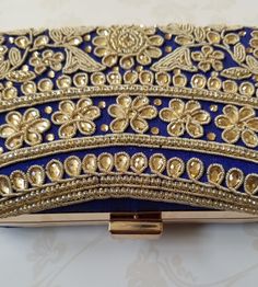 This EIRA Clutch is a stylish and unique accessory. Crafted with intricate embroidery in an eye-catching design, it's a sophisticated and versatile piece for your wardrobe. Perfect for adding a touch of flair to any outfit! Approximate Size: 20cm (L) x 4cm (W) x 12cm (H) Embellished Embroidered Fabric For Wedding, Elegant Gold Embroidered Fabric For Diwali, Elegant Embellished Embroidered Fabric For Formal Occasions, Elegant Floral Embroidered Fabric For Evening, Elegant Formal Floral Embroidered Fabric, Elegant Embellished Embroidered Fabric, Elegant Embroidered Fabric For Celebration, Elegant Intricate Embroidery Fabric For Evening, Elegant Festive Embroidered Fabric