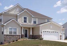 a large house with two garages in the front and one on the other side