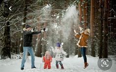 three people throwing snow in the air while standing next to two children and an adult