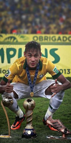 the soccer player is posing with his trophy