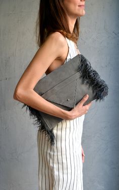 "Medusa Clutch in gray. An adorable leather clutch with fringes for beautiful fashion looks. This envelope clutch is ideal to carry anything you might need! A handmade clutch from Italian genuine suede leather in gray colour and silk fringes. The interior is fully lined with gray leatherette. It closes with one metal rivet stud in silver or gold. The pictures show the clutch with silver stud. Dimensions: Height 23 cm (9,06\"), Length 32 cm (12,6\") Do you want to use your clutch as a shoulder ba Chic Clutch Shoulder Bag With Tassels, Chic Tassel Clutch Shoulder Bag, Chic Rectangular Clutch With Fringe, Chic Rectangular Fringe Clutch, Chic Clutch With Tassels, Envelope Clutch Purse, Gray Colour, Leather Envelope Clutch, Leather Fringe Bag