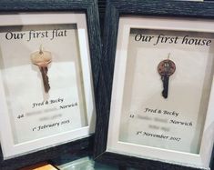 two framed keys are on display in front of the first and second place signs for our first house