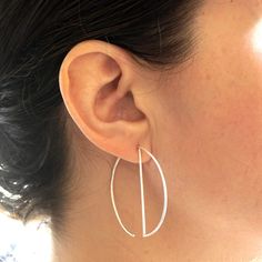 A minimal, simple, and modern design hoop earring that would certainly get attention everywhere you go.  Great for everyday wear or for a night on the town.  This simple, modern hoop dangle earring is made from solid sterling silver and has a diameter of 43mm (1.7").  + Material - Solid Sterling Silver or Yellow Gold Fill  + Diameter - 43mm (1.7")  + Finish - Matte or Polished  + Post Gauge - 20ga  + Earring Priced for a Pair  + Packaged in Kraft Box  + These Earrings do Not come with Ear Backs Design Geometric Shapes, Unique Hoop Earrings, Hoop Dangle Earrings, Geode Earrings, Hammered Hoop Earrings, Bar Stud Earrings, Open Hoop Earrings, Silver Earrings Handmade, Design Geometric