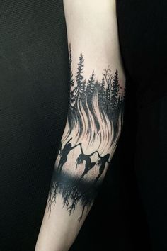 a person with a tattoo on their arm that has flames coming out of the trees