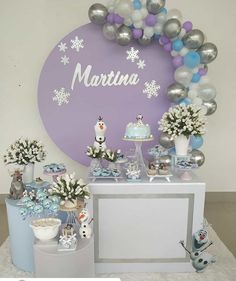 a table topped with balloons and cake next to a sign that says marinana on it