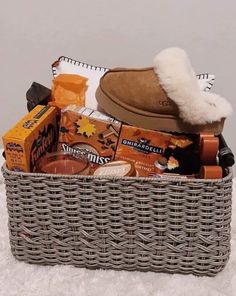 a basket filled with items sitting on top of a white blanket