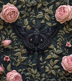 a black moth with pink roses and leaves on it's back side, surrounded by green leaves