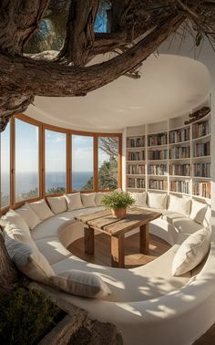 a living room filled with lots of furniture and bookshelves next to a tree