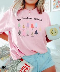 Get into the Christmas spirit with our Taylor T-Shirt! 🎄✨ Featuring Swift's 10 album Eras in a festive design, it's the ultimate holiday fashion statement. Stay cozy and stylish while celebrating the season with Swift! 🎶🎅 🌟 Disclaimer: - Colors in listings may slightly vary depending on what device you are using - Prints may appear smaller depending on the shirt size ordered Fabrication: - High-quality and super soft - Made of 100% Cotton (solid colors) and cotton-poly blend (heather colors) Pink Graphic Print Christmas Tops, Relaxed Fit Christmas T-shirt For Holiday, Pink Christmas Graphic Print Tops, Winter Pink Graphic Print T-shirt, Pink Graphic Print T-shirt For Winter, Christmas Pink Cotton Tops, Pink Cotton Christmas Tops, Christmas Pink T-shirt With Letter Print, Pink Christmas T-shirt With Letter Print