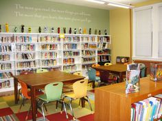 a library with tables, chairs and bookshelves filled with children's books