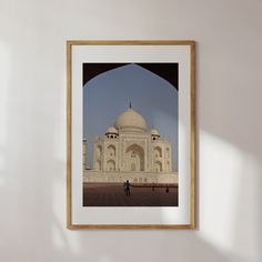 a framed photograph hanging on the wall next to a white wall with an arch in it