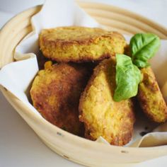 a bowl filled with fried food next to a fork