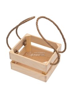 an empty wooden box with rope handles