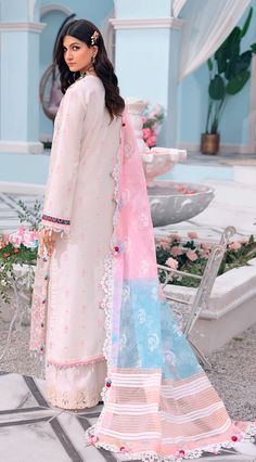 "Soft crepe pink blooms with intricate floral embroideries in 'Saiqa.' A quintessentially feminine design, it's paired with a tonal trouser and a striking dupatta in shade of complimenting taffy and a contrasting sky blue. This classic look will never go out of style. Paste Printed Woven Dupatta Embossed Printed 4 sided Dupatta Patti Embroidered Lawn Front Schiffli Jall Embroidered Lawn Back Spray Embroidered Lawn Sleeve Spray Embroidered Neckline Embroidered Front Motif Patch Embroidered Front Semi-stitched Pink Lawn Suit With Dabka Work, Pink Anarkali Lawn Suit With Intricate Embroidery, Summer Wedding Unstitched Cambric Suit, Summer Wedding Cambric Unstitched Suit, Pink Georgette Lawn Suit Straight Kurta, Pink Georgette Lawn Suit With Chikankari Embroidery, Pink Embroidered Georgette Lawn Suit, Pink Embroidered Kurta For Eid, Elegant Pink Lawn Suit With Chikankari Embroidery