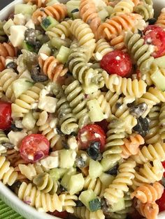 a bowl filled with pasta salad on top of a table