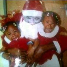 an old photo of two children and a cat wearing santa claus's hat on their heads