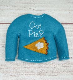 a blue sweater with a piece of pizza embroidered on the front that says got pie?