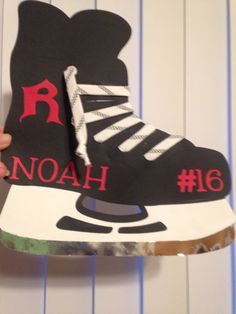 someone is holding up a cardboard shoe with the word noah on it's side