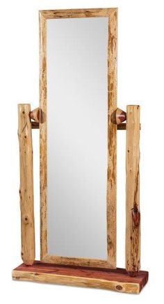 a mirror sitting on top of a wooden shelf next to a mirror and some logs