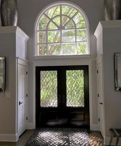 an entryway with arched windows and doors