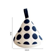 a white and blue polka dot covered pot holder with black trim on the top, measurements