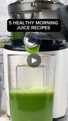 a blender filled with green liquid on top of a counter