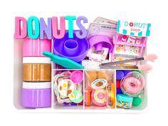 a plastic container filled with lots of toys and doughnuts on top of it