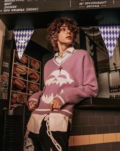 a woman standing in front of a counter with donuts hanging from it's sides