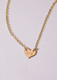 Engraved Heart Everyday Gold Engraved Heart Necklace, Heart-shaped Engraved Initial Necklace For Anniversary, Gold Engraved Heart Pendant Initial Necklace, Gold Initial Necklace With Engraved Heart Pendant, Gold Heart Initial Necklace For Anniversary, Gold Heart-shaped Stamped Jewelry, Gold Heart Charm Necklace With Nameplate, Heart-shaped Stamped Necklace For Personalized Gift, Personalized Heart-shaped Stamped Necklaces