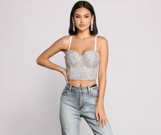 Bring on the bling in this glamorous rhinestone cropped bustier! It features a sleeveless bodice with all over front rhinestone embellishment. Pair with a sleek faux leather mini skirt and glimmering earrings to complete your going out look.Fit & Features Adjustable spaghetti straps Sweetheart neckline Bustier top Cropped hem Back hook and eye closures Rhinestone embellishment Elegant Fitted Rhinestone Crop Top, Glamorous Sweetheart Neckline Tube Top, Glamorous Tube Top With Sweetheart Neckline, Glamorous Fitted Crop Top With Sweetheart Neckline, Sleeveless Rhinestone Evening Crop Top, Sleeveless Rhinestones Crop Top For Evening, Sleeveless Evening Crop Top With Rhinestones, Evening Crop Top With Rhinestones, Glamorous Fitted Crop Top With Rhinestones