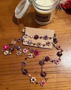 a candle and some beads on a table