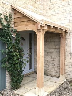 an outside view of a house with a wooden pergolan on the front porch