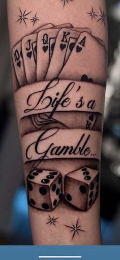 a man's arm with some dices on it and the words life is a gambling