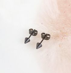 *Black Spike Studs. *Surgical Steel. *Hypoallergenic. *Sold as a pair (2). *Nickel Free. *Unisex. Minimalist Black Plug Earrings For Gift, Trendy Black Stud Jewelry, Trendy Black Studded Jewelry, Black Minimalist Plug Earrings, Nickel-free Black Punk Earrings, Black Nickel-free Punk Earrings, Edgy Black Adjustable Earrings, Black Punk Plug Earrings For Gift, Black Punk Plug Earrings As Gift