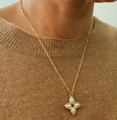 This Square Pearl Cross Necklace features a unique cross shape and classic pearl detailing, giving it a timeless and elegant look. Its versatile design allows for layering, making it a perfect addition to any outfit. Dimensions: approximately 16" chain with a 2" extender, pendant 1" drop Gold plated metal, acrylic pearl Lead and Nickel compliant Elegant Cross Pendant Necklace With Pearl Drop, Elegant Cross Necklace With Pearl Pendant, Elegant Pearl Drop Cross Pendant Necklace, Elegant Cross Necklace With Pearl Drop, Elegant Metal Cross Necklace With Adjustable Chain, Elegant Gold Cross Necklace With Pearl Pendant, Gold Pearl Cross Pendant Necklace, Elegant Cross-shaped Pearl Necklace, Elegant Cross-shaped Pearl Necklace For Gifts